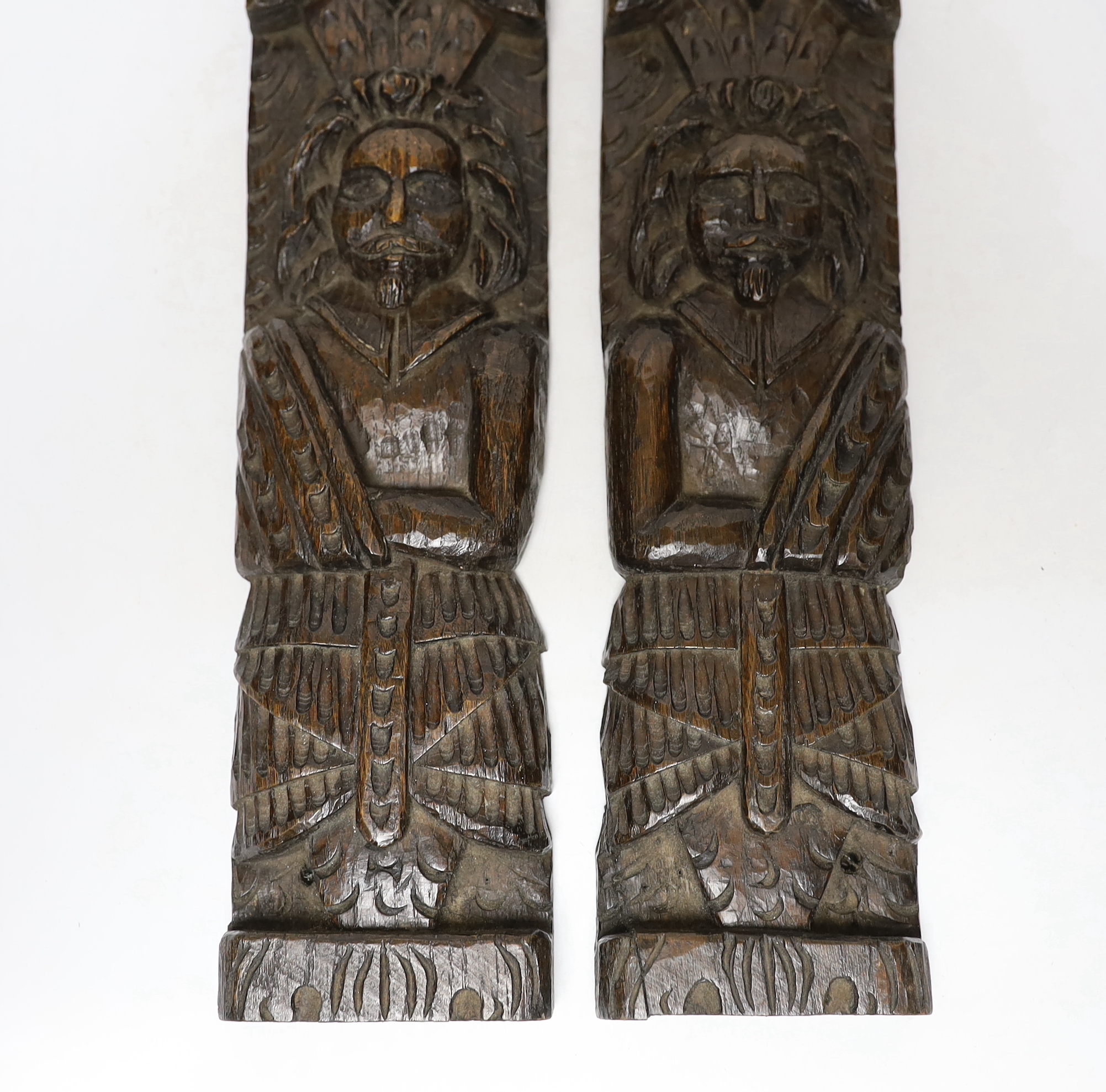 A pair of 17th century carved oak figural jambs, 43.5cm